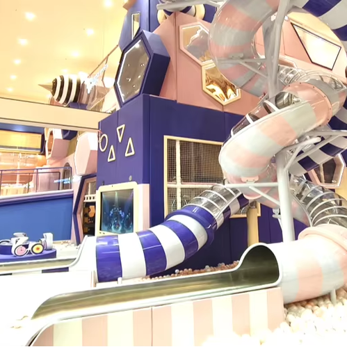 Parque de aventuras infantil interior comercial con juego interactivo colorido
